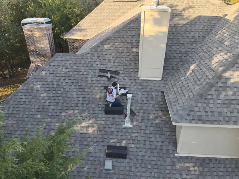 Crew member repairing roof