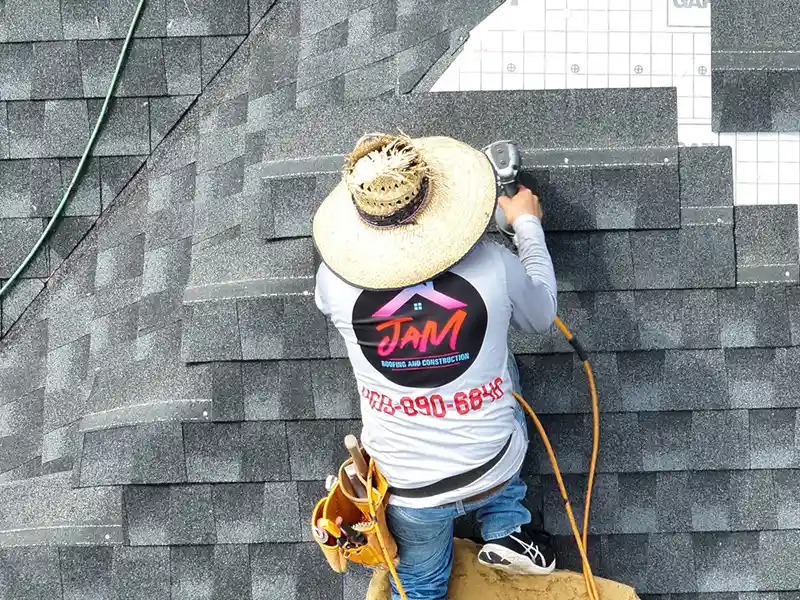 Crew member installing shingles